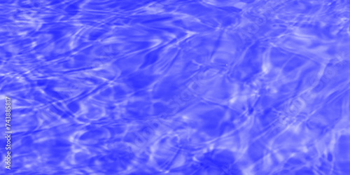 Modern Vivid deep blue water background. Transparent water in pool. Blue water with ripples on the surface. Defocus blurred blue water shining in the sea. rippled water detail background. 