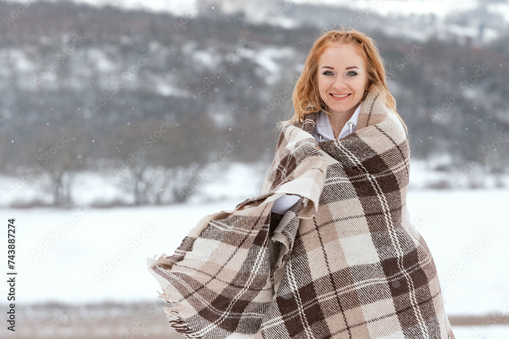 Outdoor photo of young beautiful happy smiling red-haired woman in snowy day. Winter time. Outdoor photo of young beautiful happy smiling red-haired woman in snowy day. Winter time.