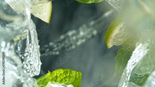 Macro Shot of Mojito Drink Pouring into Glass.