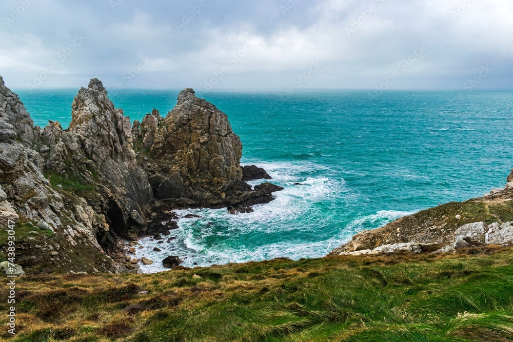 Dark cliffs over the emerald sea in Brittany