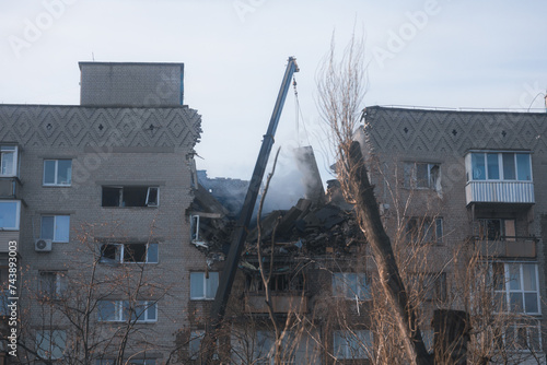An attack drone (shahed) hit the roof of a house. Rocket attack on a residential building in the city of Dnepr. Consequences after a strong explosion. War in Ukraine and Russia. People under the rubbl