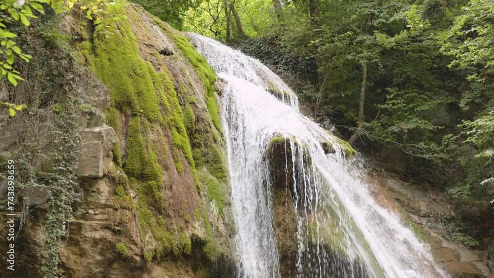 Mountain waterfall with water splashes in forest. Mountain waterfall with water splashes in forest.