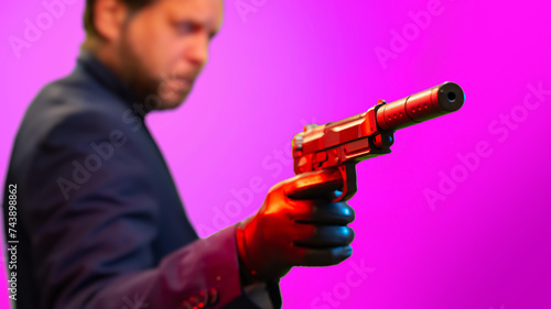 close-up of a pistol with a silencer in the killer's hand