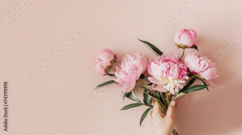 Elegant pink peonies bouquet with copy space on a pastel background, perfect for Mother's Day or spring-themed designs © fotogurmespb