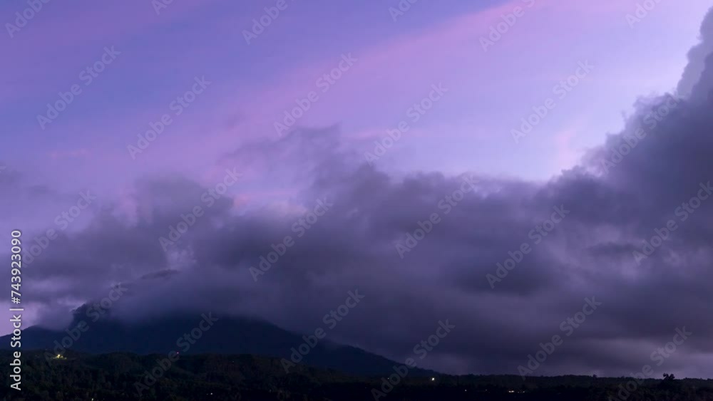 Timelapse of clouds traveling over a dense forest at dusk, mountains of Bali near Munduk, Indonesia Timelapse of clouds traveling over a dense forest at dusk, mountains of Bali near Munduk, Indonesia