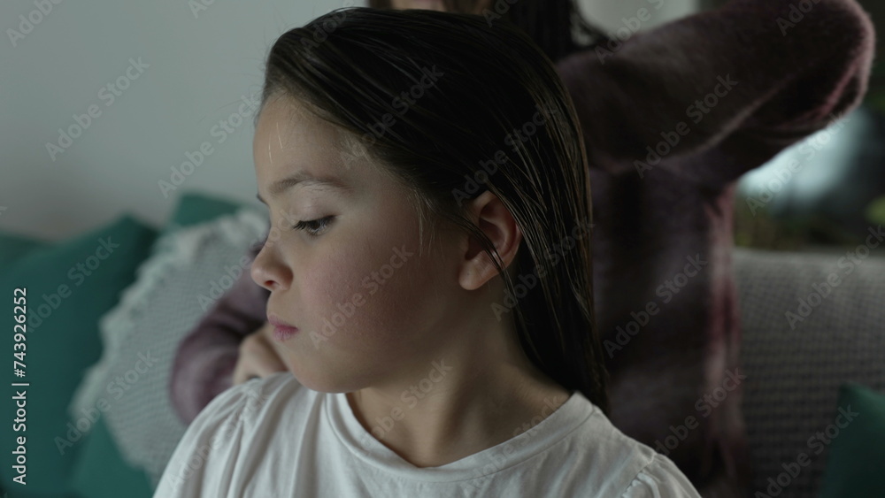 Family Bedtime Routine, Mother Gently Combing Daughter's Hair at Night Family Bedtime Routine, Mother Gently Combing Daughter's Hair at Night