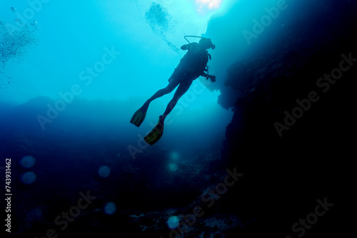 Silhouette of scuba divers underwater. Diving concept. Beautiful underwater world. Underwater photography.