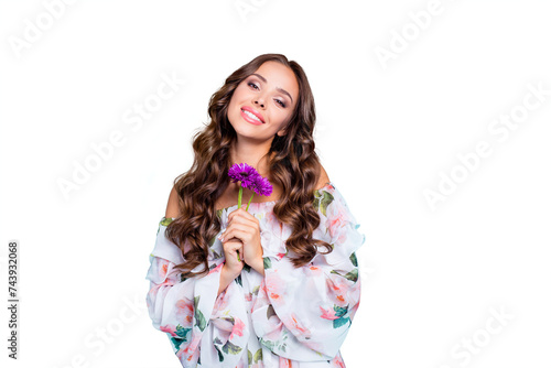 Portrait of beautiful, attractive, pretty, dreamy, charming, lovely person hold purple bouquet of flowers in hands and look at camera tilt head aside isolated on shine teal background © deagreez