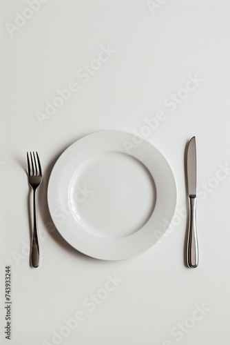 White Plate with Cutlery on Minimalist Background