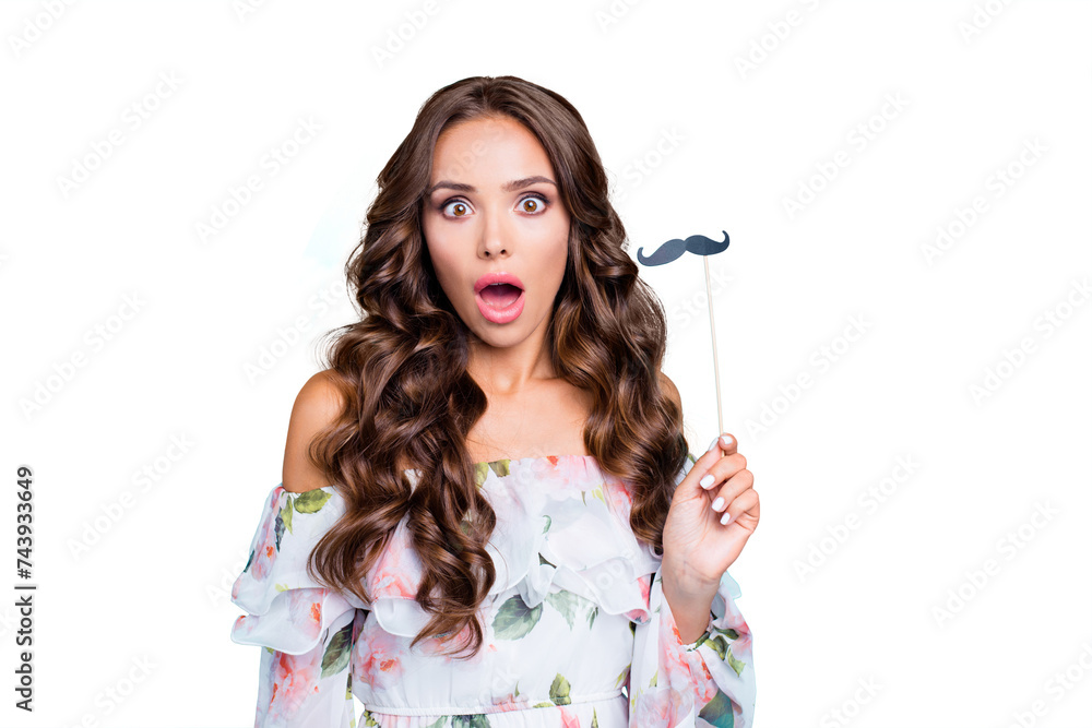 Close up portrait of shocked face brunette woman with wide open mouth, big eyes and fake mustache on stick in hands isolated on bright turquoise background Close up portrait of shocked face brunette woman with wide open mouth, big eyes and fake mustache on stick in hands isolated on bright turquoise background