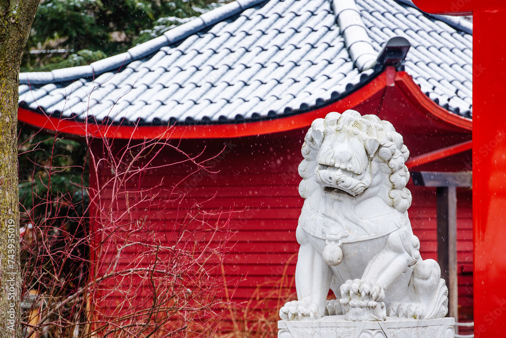 Fototapeta premium Granby, Quebec - Dec 31 2023: Beautiful chinese style pavillon snow covered in the winter Granby Zoo 