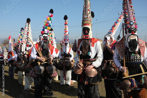 People called Kukeri parade in masks and ritual costumes, perform ritual dances to drive away evil spirits in the town of Elin Pelin, Bulgaria. photo