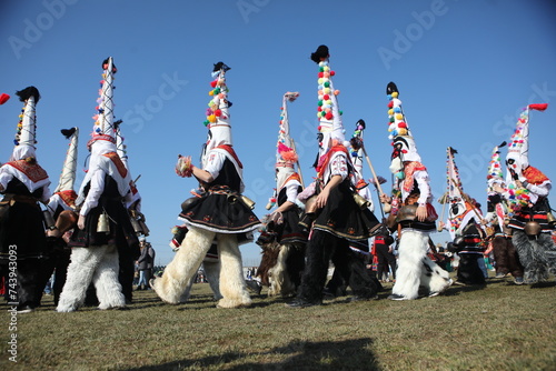 People called Kukeri parade in masks and ritual costumes, perform ritual dances to drive away evil spirits in the town of Elin Pelin, Bulgaria. photo