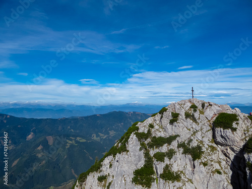 Fototapeta Naklejka Na Ścianę i Meble -  Scenic view of summit cross of majestic mountain peak Hochlantsch in Graz Highlands, Prealps East of the Mur, Styria, Austria. Wanderlust Austrian Alps. Idyllic hiking trail in alpine nature in summer