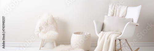 White and cream minimalist home interior with a furry rocking chair, sheepskin rug, and basket