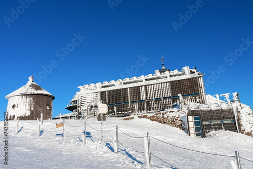 Wooden building of new post office and Roman catholic chapel in snezka, mountain on the border between Czech Republic and Poland, winter morning