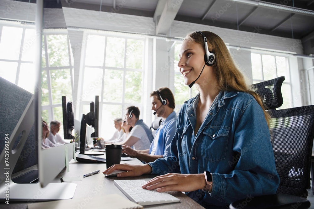 Young friendly operator woman agent with headsets working in a call center. Young friendly operator woman agent with headsets working in a call center.