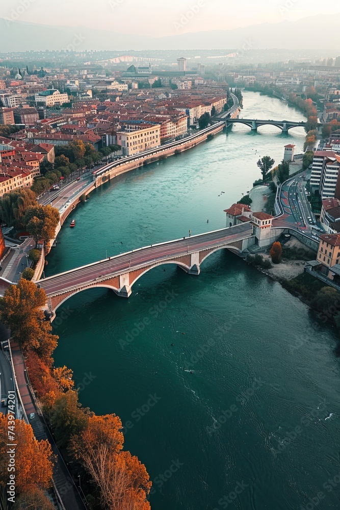 Naklejka premium An aerial perspective showing a bridge stretching across a river, connecting one side to the other. The bridge is prominent, allowing vehicles and pedestrians to traverse the water body below
