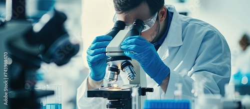 Microbiologist examining bi...