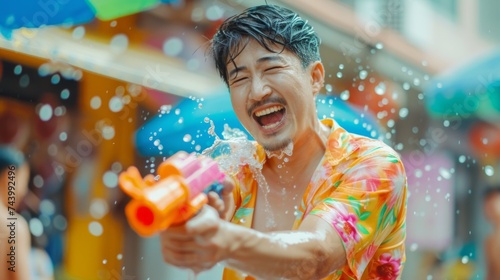 People with water gun wearing summer shirt in Songkran water festival photo