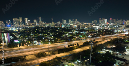 Aerial view of american highway junction at night with fast driving vehicles in Miami, Florida. View from above of USA transportation infrastructure