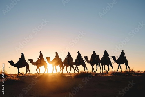 Silhouette people riding camels in desert native tuareg arabic african person Sahara wildlife tourist attraction Dubai arab tour sunset caravan adventure long journey tour dune sun Bible story Quran photo