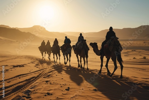 Silhouette people riding camels in desert native tuareg arabic african person Sahara wildlife tourist attraction Dubai arab tour sunset caravan adventure long journey tour dune sun Bible story Quran © Yuliia