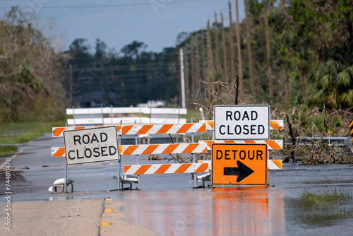 Tableau sur toile Hurricane flooded street with road closed signs blocking driving of cars