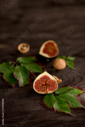 sliced juicy figs on a dark wooden background.