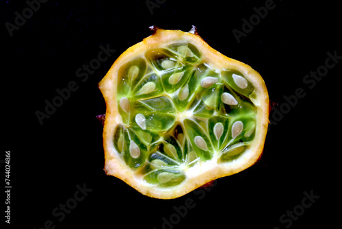 Cross section of a kiwano on slate background for food illustrations