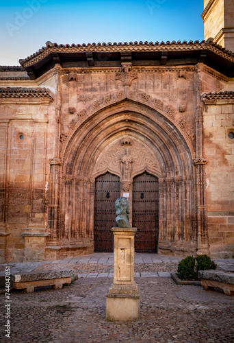 Vertical detail of the Gothic entrance to the Church of the Santísima Trinidad de Alcaraz, Albaete, Castilla la Mancha, Spain with the monument to Andrés de Vandelvira photo