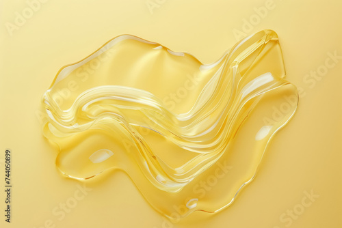 smooth golden texture of honey-like cosmetic gel on yellow background