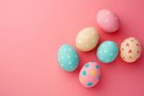 Pastel Easter eggs adorned with patterns on a pink backdrop, conveying a soft, festive mood. Ideal for minimalist holiday design.