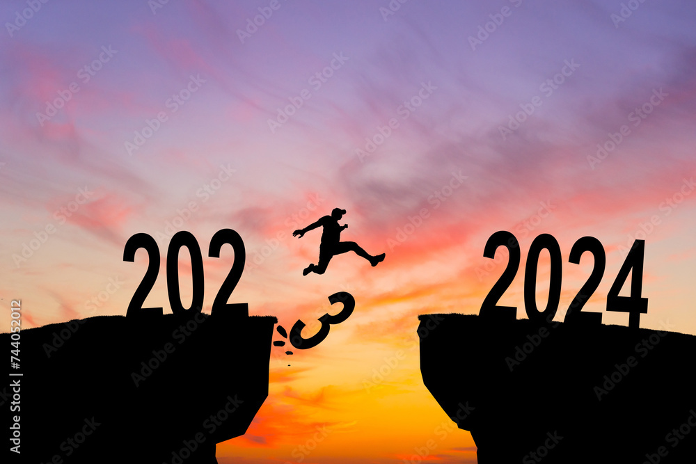 Man jumping on cliff 2024 over the precipice with stones at amazing sunset. New Year's concept. 2023 falls into the abyss. Welcome 2024. People enters the year 2024, creative idea. Man jumping on cliff 2024 over the precipice with stones at amazing sunset. New Year's concept. 2023 falls into the abyss. Welcome 2024. People enters the year 2024, creative idea.