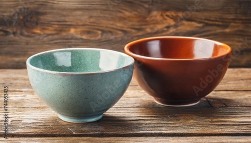 two ceramic bowls on wooden background