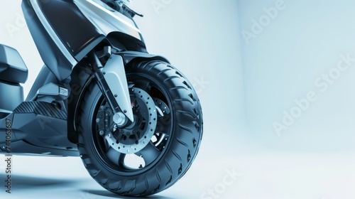 A close-up of the front wheel of a motorcycle parked on a sidewalk. 