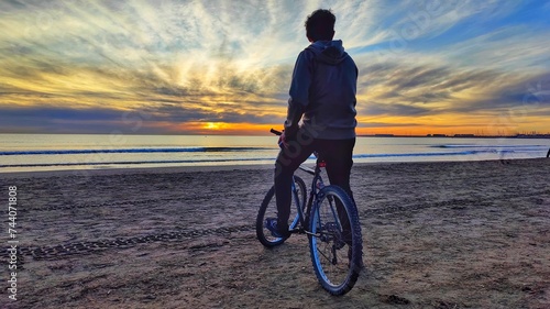 receiving the sunrise on Cabanyal beach photo