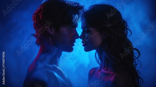  a man and a woman standing next to each other in front of a blue background with smoke coming out of the back of the man s face and the woman s head.