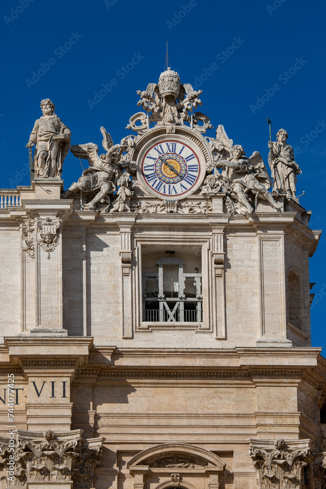 Facade of  Saint Peter's Basilica with decorative clock on a top, Vatican, Rome, Italy