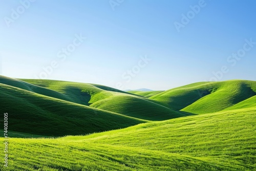 A photo featuring a wide expanse of green field extending towards the horizon, with a clear blue sky as the backdrop, Lush green hills under a clear blue sky, AI Generated
