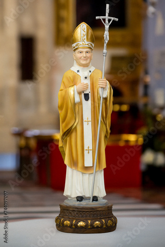 Statue of John Paul the Second in blurred religious church background photo