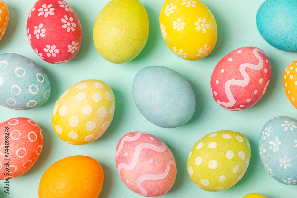 Easter eggs on a bright turquoise background. Easter celebration concept. Colorful easter handmade decorated Easter eggs. Place for text. Copy space. Easter eggs on a bright turquoise background. Easter celebration concept. Colorful easter handmade decorated Easter eggs. Place for text. Copy space.