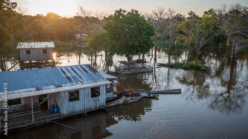 Aerial view of a flooded area (igapó) and houses on stilts, based on the traditional knowledge and venacular architecture of the Brazilian Amazon, in the community of Xiborena near Manaus (AM) photo