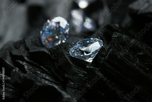 Beautiful shiny diamonds on coals, closeup view