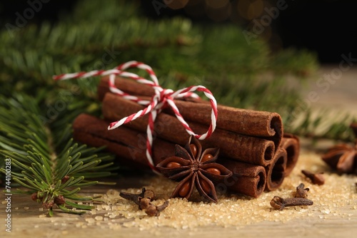 Different spices and fir branches on table, closeup