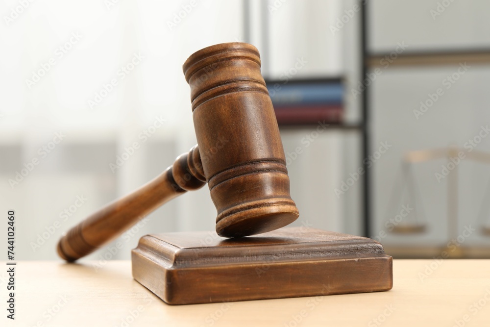 Wooden gavel and sound block on table indoors, closeup Wooden gavel and sound block on table indoors, closeup