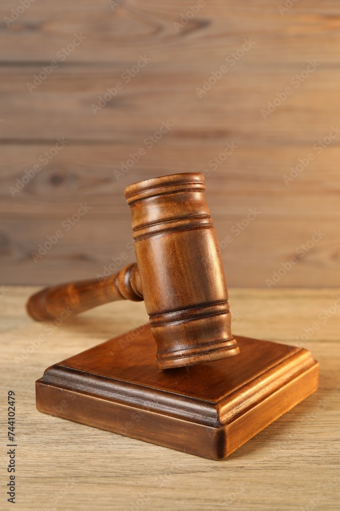 Wooden gavel and sound block on table
