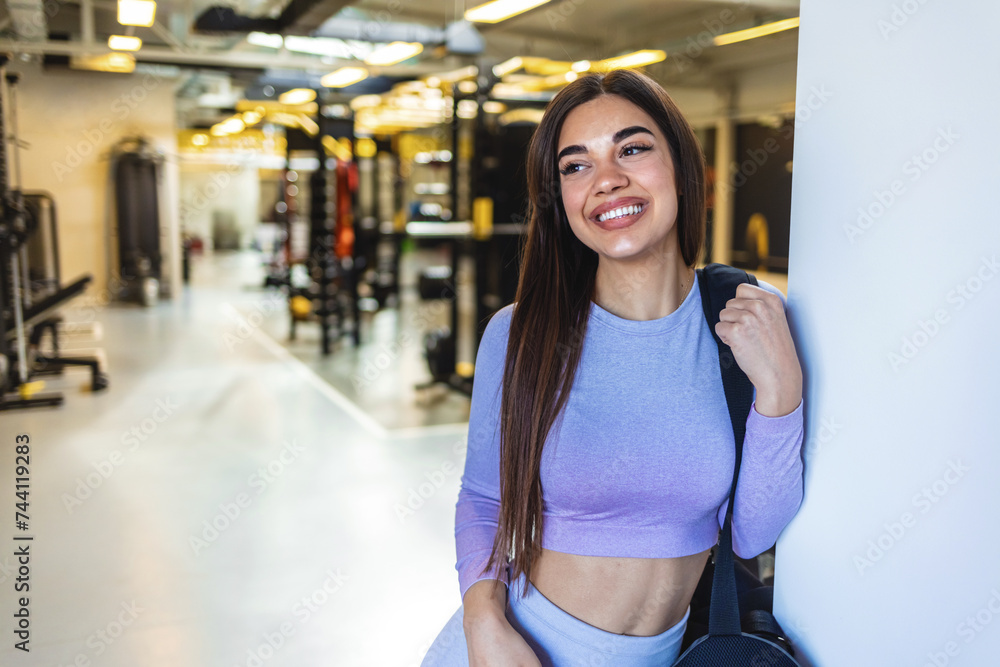 Happy young woman, gym portrait and backpack for training, exercise lifestyle or body wellness. Headshot, fitness and happiness on face, health or workout for Caucasian girl, woman or model with bag.
