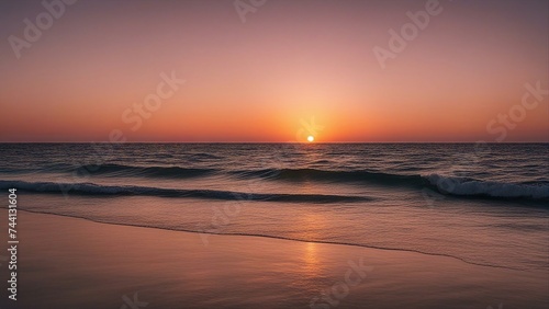 sunset at the beach A relaxing and calm sea view with open ocean water and sunset sky. The water is blue and clear, 
