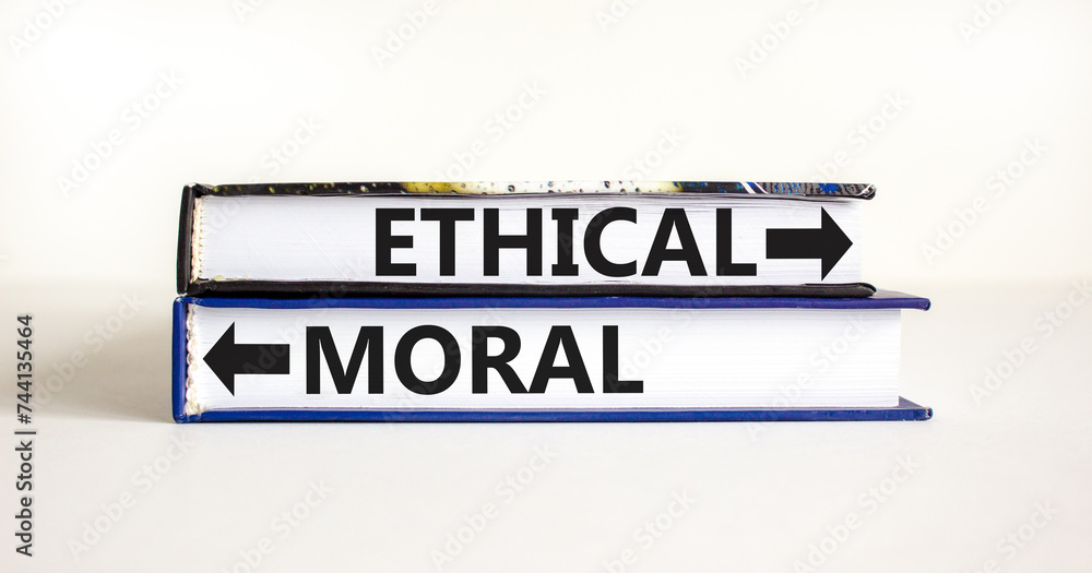 Ethical or moral symbol. Concept word Ethical or Moral on beautiful books. Beautiful white table white background. Business and ethical or moral concept. Copy space.